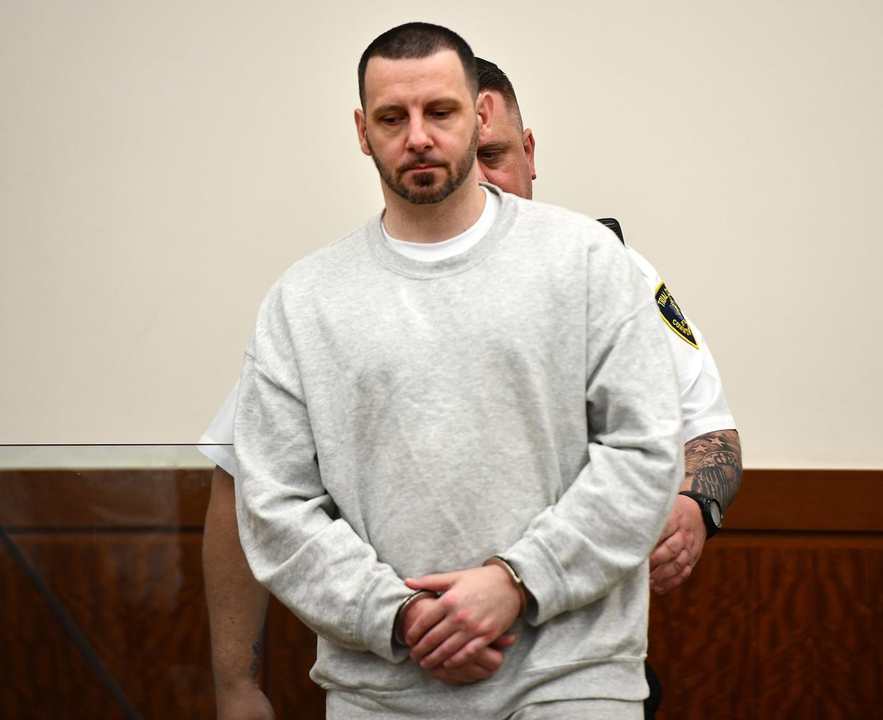 Mathew Locke enters the courtroom for a hearing Thursday. He is charged in the deaths of a West Brookfield mother and three children. Authorities say his DNA was found on one of the bodies of the slain children.