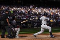 Milwaukee Brewers' Victor Caratini hits an RBI single during the seventh inning of a baseball game against the San Francisco Giants Saturday, May 27, 2023, in Milwaukee. (AP Photo/Morry Gash)