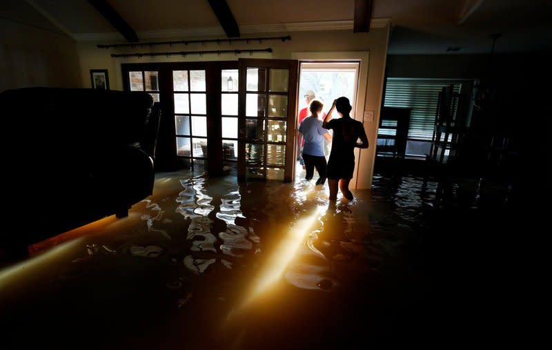 A family that wanted to remain anonymous moves belongings from their home flooded by Harvey in Houston, Texas August 31, 2017. REUTERS/Rick Wilking
