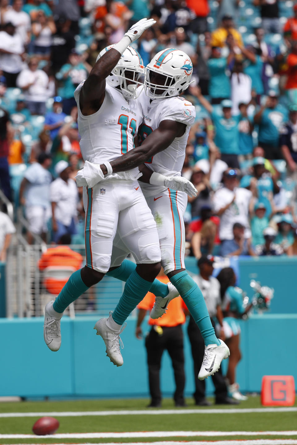 Miami Dolphins wide receiver Preston Williams (18) congratulates wide receiver DeVante Parker (11), after Parker scored a touchdown, during the first half at an NFL football game against the Los Angeles Chargers, Sunday, Sept. 29, 2019, in Miami Gardens, Fla. AP Photo/Wilfredo Lee)