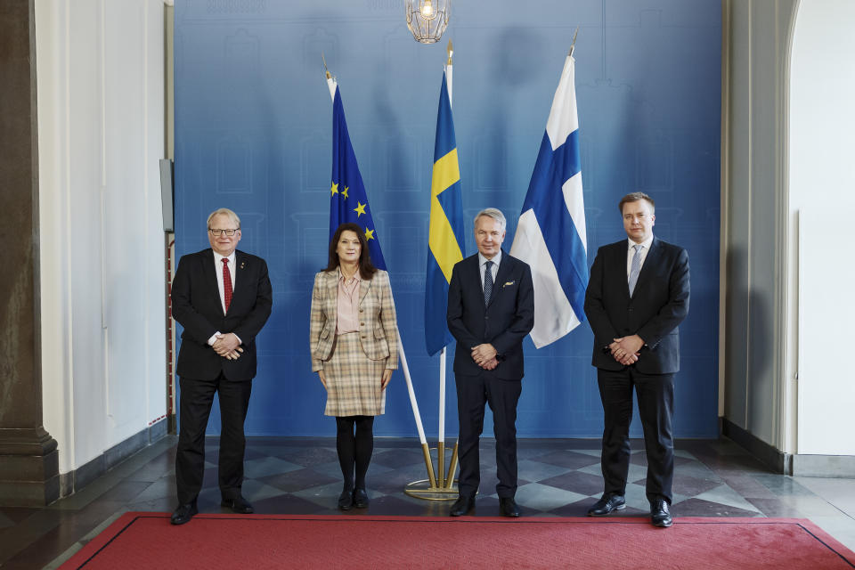 From left, Sweden's Defence Minister Peter Hultqvist, Sweden's Minister for Foreign Affairs Ann Linde, Finland's Minister for Foreign Affairs Pekka Haavisto and Finland's Defence Minister Antti Kaikkonen pose during a photo call in Stockholm, Wednesday, Feb. 2, 2022. The Finnish ministers visit Stockholm for talks on European security. (Paul Wennerholm/TT News Agency via AP)