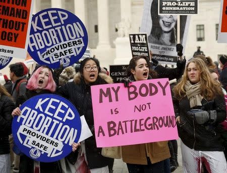 Pro-abortion supporters demonstrate in front of the U.S. Supreme Court (not pictured) during the National March for Life rally in Washington January 22, 2016. REUTERS/Gary Cameron