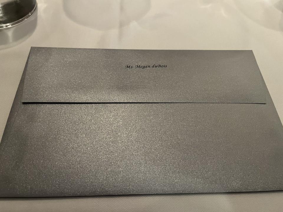 silver personalized envelope with the menu at Victoria and alberts inside
