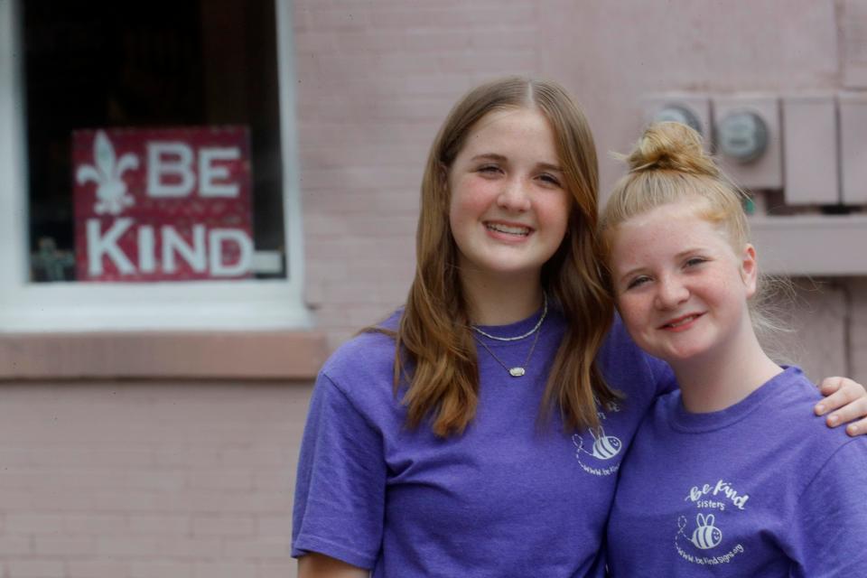 Raegan and Rylyn Richins in front of one of their Be Kind signs that they have created. They thought Oldham County needed a little more kindness. June 21, 2023