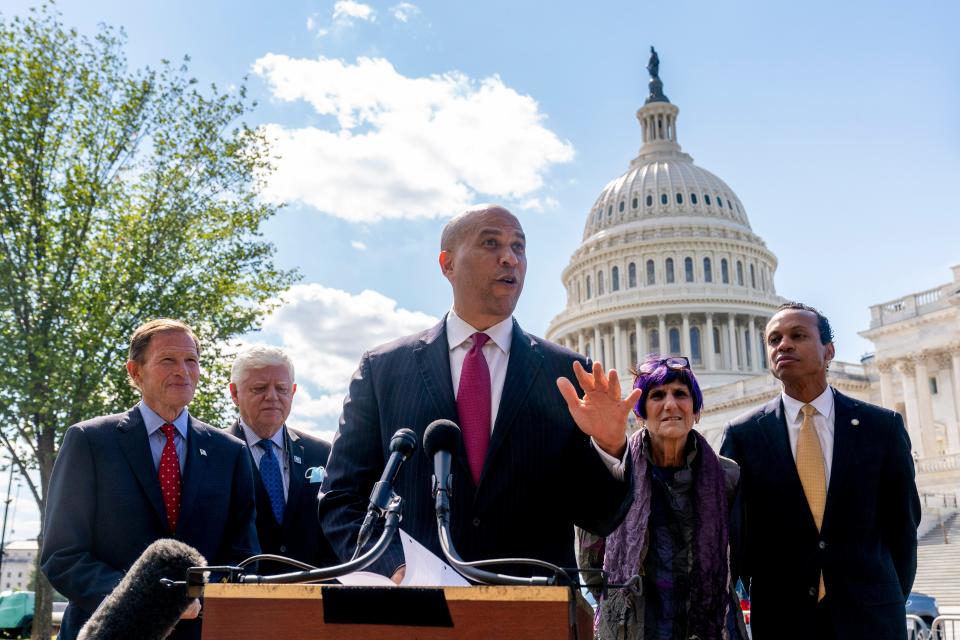 Sen. Cory Booker, D-N.J., center, accompanied by Sen. Richard Blumenthal, D-Conn., (left) and others at a news conference on Capitol Hill in Washington, Thursday, Sept. 30, 2021.