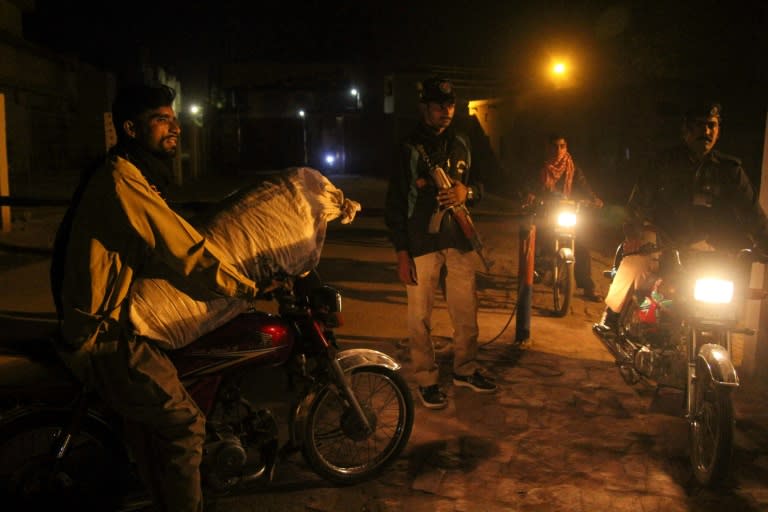 Pakistani police stand guard at the gates of the central jail where Asia Bibi was held in Multan