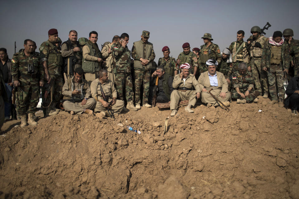 FILE -- In this Nov. 7, 2016 file photo, Kurdish Peshmerga fighters and commanders overlook Islamic State group positions during heavy fighting in Bashiqa, east of Mosul, Iraq. Syria’s Kurds have been America’s partner in fighting the Islamic State group for nearly four years. Now they are furious over an abrupt U.S. troop pull-back that exposes them to a threatened attack by their nemesis, Turkey. The surprise U.S. pull-back from positions near the Turkish border, which began Monday, Oct. 7, 2019, stung even more because the Kurds have been abandoned before by the U.S. and other international allies on whose support they'd pinned their aspirations. (AP Photo/Felipe Dana, File)
