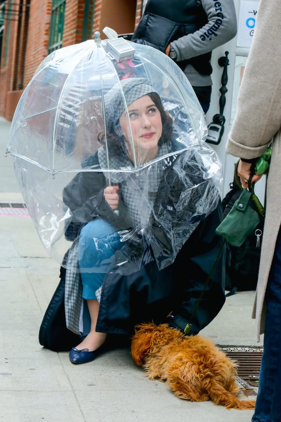 <p>Arguably the best photos from set are those of Brosnahan stopping to pet puppies while filming. </p>