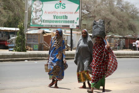 Women flee with their belongings on the road in Maiduguri in Borno State, Nigeria May 14, 2015. REUTERS/Stringer