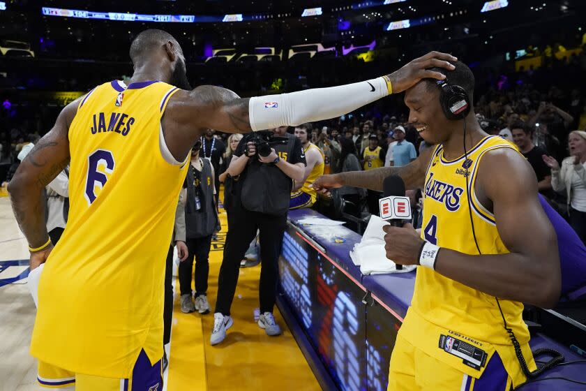 Los Angeles Lakers' LeBron James, left, congratulates Lonnie Walker IV after the Lakers defeated the Golden State Warriors 104-101 in Game 4 of an NBA basketball Western Conference semifinal Monday, May 8, 2023, in Los Angeles. (AP Photo/Marcio Jose Sanchez)