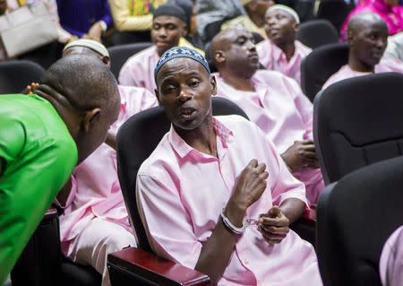 Unidentified suspects talk inside the Rwandan high court after being convicted of belonging to extremist groups including al Shabaab and Islamic State and providing them support, in Nyanza, Rwanda March 22, 2019. REUTERS/Jean Bizimana