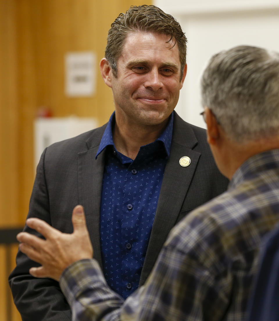 In this Tuesday, Oct. 15, 2019 photo, Virginia Del. Nick Freitas speaks to a supporter prior to a town hall in Lake of Woods, Va. Freitas is running a write in campaign after a paperwork error left his off the November ballot. (AP Photo/Steve Helber)