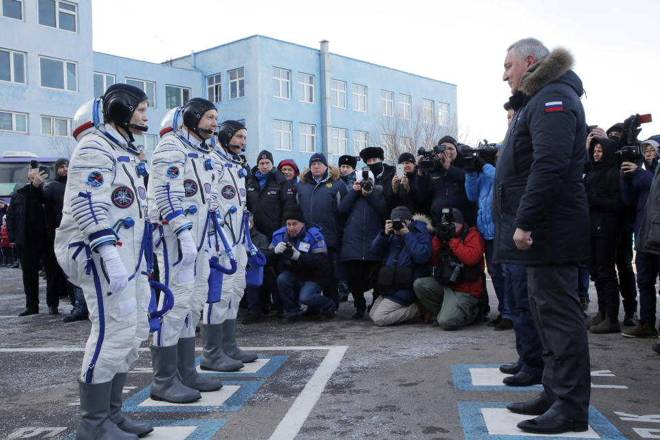 U.S. astronaut Anne McClain, left, Russian cosmonaut Оleg Kononenko‎, centre, and CSA astronaut David Saint Jacques, members of the main crew of the expedition to the International Space Station (ISS), report to head or Russian space agency Dmitry Rogozin prior to the launch of Soyuz MS-11 space ship at the Russian leased Baikonur cosmodrome, Kazakhstan, Monday, Dec. 3, 2018. (AP Photo/Dmitri Lovetsky, Pool)