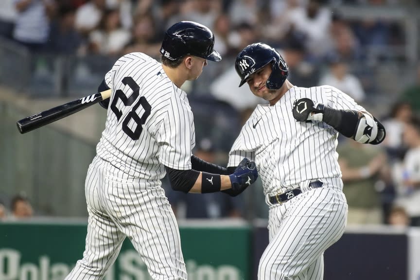 New York Yankees second baseman Gleyber Torres (25) celebrates with third baseman Josh Donaldson (28) after hitting a solo home run in the fourth inning against the Boston Red Sox at Yankee Stadium.