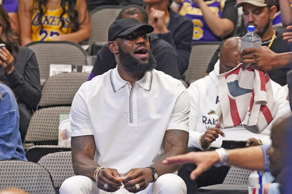 Los Angeles Lakers forward LeBron James sits on the bench during the first quarter of an NBA basketball game against the Dallas Mavericks in Dallas, Tuesday, March 29, 2022. (AP Photo/LM Otero)