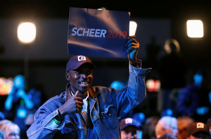 An Andrew Scheer supporter cheers for results coming in at the Scheer campaign headquarters during the federal election in Regina