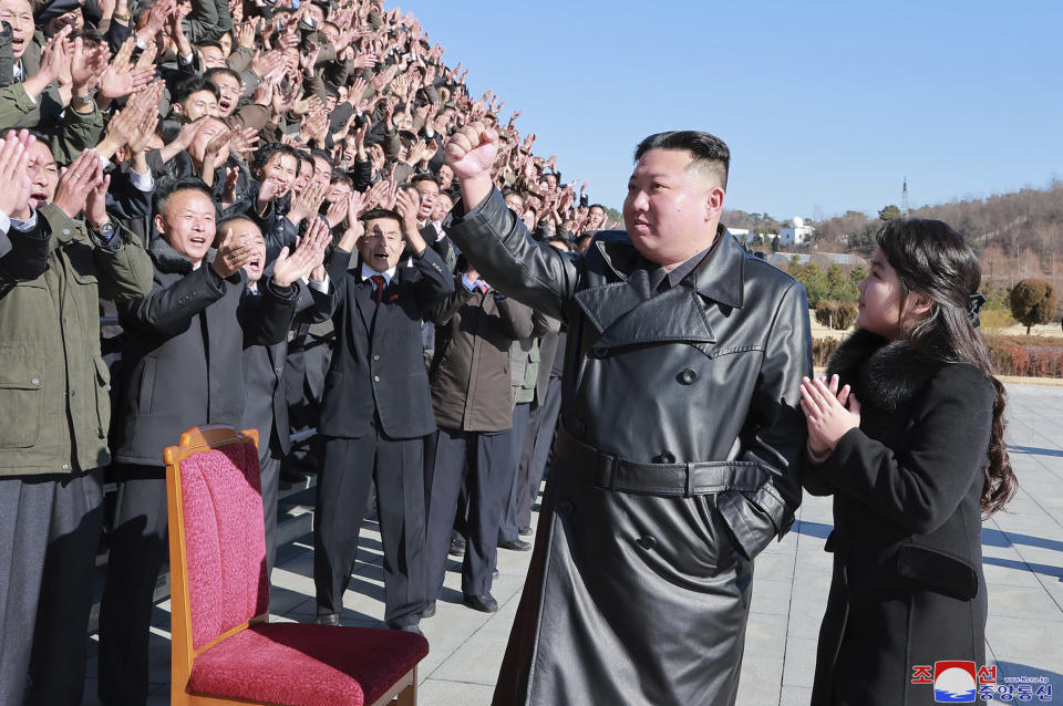 This undated photo provided on Nov. 27, 2022, by the North Korean government shows North Korean leader Kim Jong Un, center, with his daughter, center right, waves to scientists and workers, following the launch of what it says a Hwasong-17 intercontinental ballistic missile, at an unidentified location in North Korea. Independent journalists were not given access to cover the event depicted in this image distributed by the North Korean government. The content of this image is as provided and cannot be independently verified. Korean language watermark on image as provided by source reads: "KCNA" which is the abbreviation for Korean Central News Agency. (Korean Central News Agency/Korea News Service via AP)