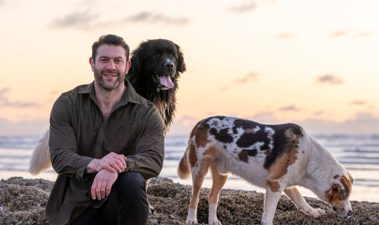 Animal rescue icon Lee Asher of Asher House with two members of his "pack."