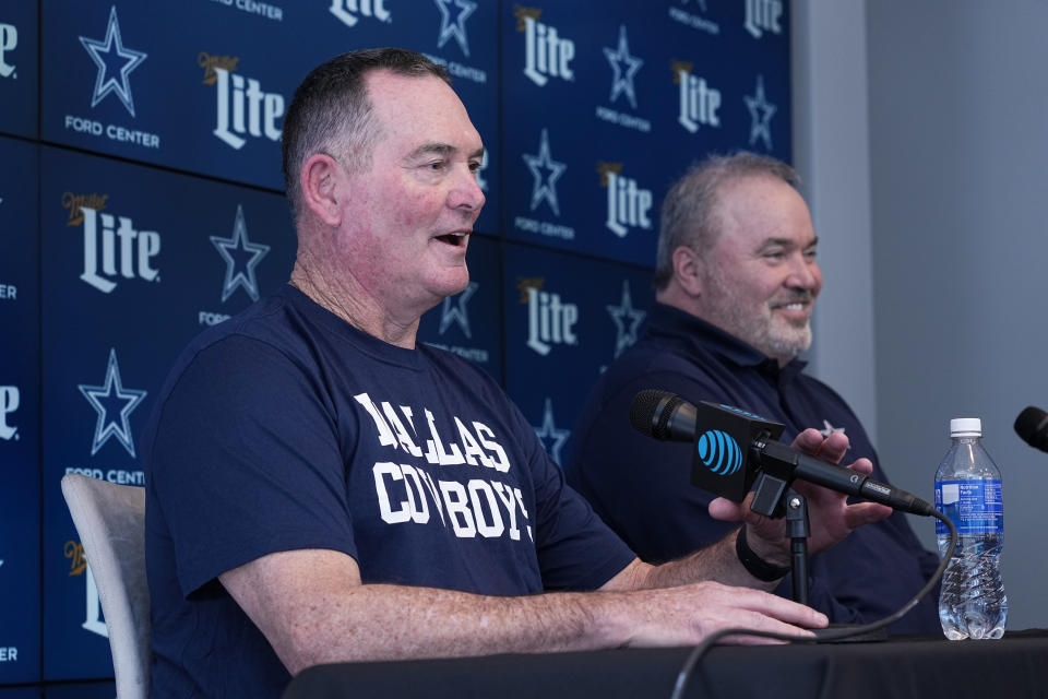 Mike Zimmer, left, addresses a reporters question as Dallas Cowboys head coach Mike McCarthy, right, smiles, during a news conference where Zimmer was introduced as the new defensive coordinator at the teams NFL football headquarters in Frisco, Texas, Wednesday, Feb. 14, 2024. (AP Photo/Tony Gutierrez)