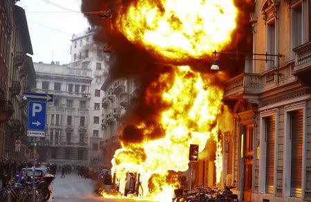 Cars are set on fire by protesters during a rally against Expo 2015 in Milan, May 1, 2015. REUTERS/Stefano Rellandini