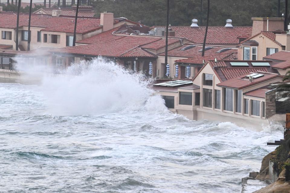 Waves crash into the windows of the Marine Room restaurant Tuesday, Jan. 23, 2024, in La Jolla, Calif. The restaurant is reinforced for the surf and no damage was done. California Gov. Gavin Newsom declared a state of emergency for San Diego County and Ventura County, which was also hit by heavy rains that caused flooding there in late December, stating that “I find that local authority is inadequate to cope with the magnitude of the damage caused by these winter storms.”