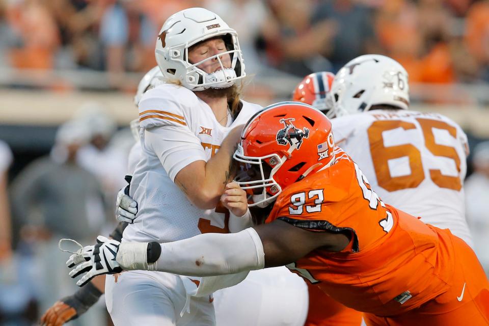 Oklahoma State defensive tackle Collin Clay hits Texas quarterback Quinn Ewers during the Cowboys' 41-34 win in Stillwater two weeks ago. Ewers threw three interceptions in the loss. "One game should never define us," UT coach Steve Sarkisian said. "You've got to get back to work, you've got to get back on the horse and you've got to start riding again."