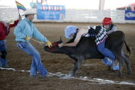 Raymond Norris, 45, rides a steer while competing in the Wild Drag Race at the International Gay Rodeo Association's Rodeo In the Rock in Little Rock, Arkansas, United States April 25, 2015. REUTERS/Lucy Nicholson