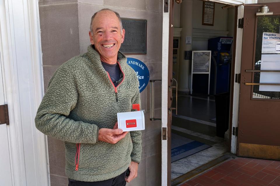 File - Netflix's first CEO, Marc Randolph, poses outside the Santa Cruz, California, post office in May, 2022, where he had mailed a Patsy Cline CD to the company's co-founder Reed Hastings, to test whether a disc could make it through the mail. The Netflix DVD-by-service will mail out its final discs Friday from its five remaining distribution centers, ending its 25-year history. (AP Photo/Mike Liedtke, File)