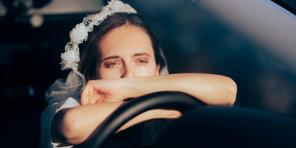 unhappy bride crying in her car cancelling her wedding