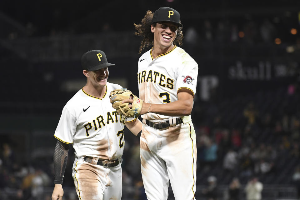 Pittsburgh Pirates' Cole Tucker (3) reacts with Kevin Newman (27) after a double play in the seventh inning against the Cincinnati Reds during a baseball game in Pittsburgh, Friday, Oct. 1, 2021. (AP Photo/Philip G. Pavely)