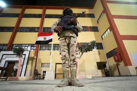 A soldier stands guard outside a polling station during ballots counting on the final day of the referendum on draft constitutional amendments, in Cairo, Egypt April 22, 2019. REUTERS/Mohamed Abd El Ghany