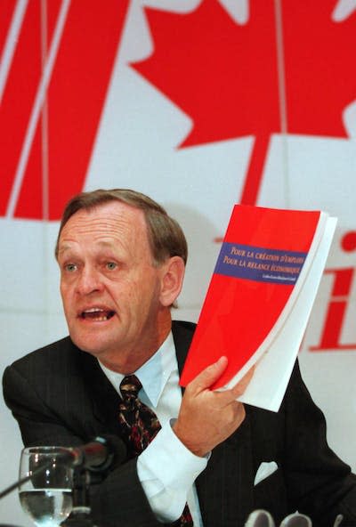 Jean Chrétien holds a copy of the Liberal Red Book during the 1993 election campaign. CP PICTURE ARCHIVE/Tom Hanson