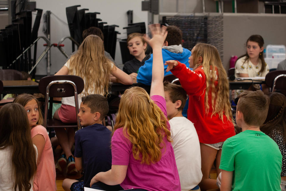 Amy Guman raises her hand to answer a question during the "Vinal Book Bee" at Vinal Elementary School in Norwell Friday, May 27, 2022.