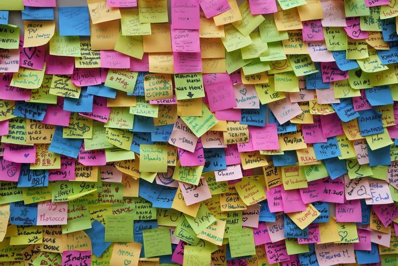 Messages are stuck to a wall outside the Indonesia Pavilion at the COP28 U.N. Climate Summit, Dec. 10, 2023, in Dubai, United Arab Emirates.