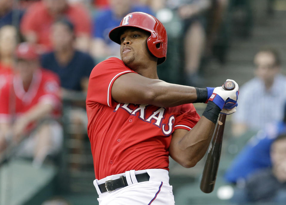 Texas Rangers' Adrian Beltre follows through on a run-scoring double off a pitch from Boston Red Sox's Clay Buchholz in the first inning of a baseball game, Friday, May 9, 2014, in Arlington, Texas. The hit scored Elvis Andrus. (AP Photo/Tony Gutierrez)