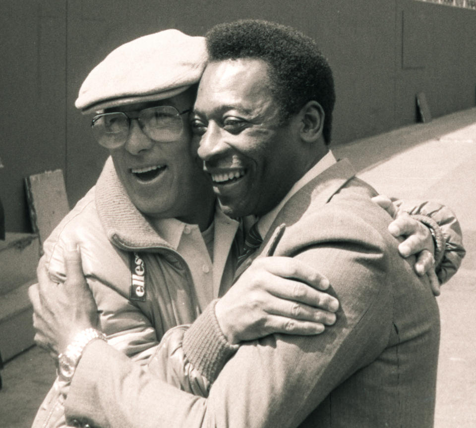 FILE - Brazilian soccer star Pele, and New York Cosmos coach Julio Mazzei, embrace at Giants Stadium in East Rutherford, N.J., April 16, 1982. Mazzei helped persuaded Pele to play in the United States and coached the Cosmos to a North American Soccer League title in 1982. Pelé, the Brazilian king of soccer who won a record three World Cups and became one of the most commanding sports figures of the last century, died in Sao Paulo on Thursday, Dec. 29, 2022. He was 82. (AP Photo/Seth Rubenstein, File)