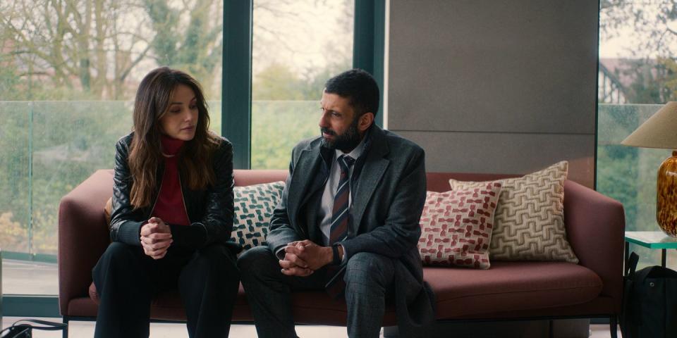 michelle keegan as maya stern, adeel akhtar as ds sami kierce sitting on a sofa in netflix's fool me once