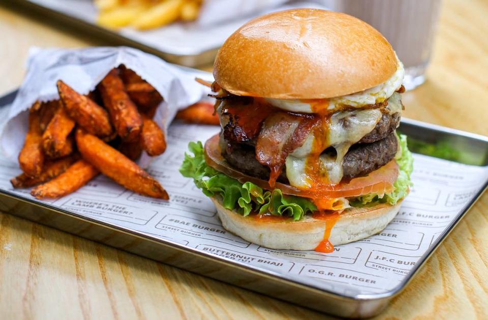 Gordon Ramsay’s #BAE Burger is topped with bacon, and over easy egg, cheese and tomato relish.