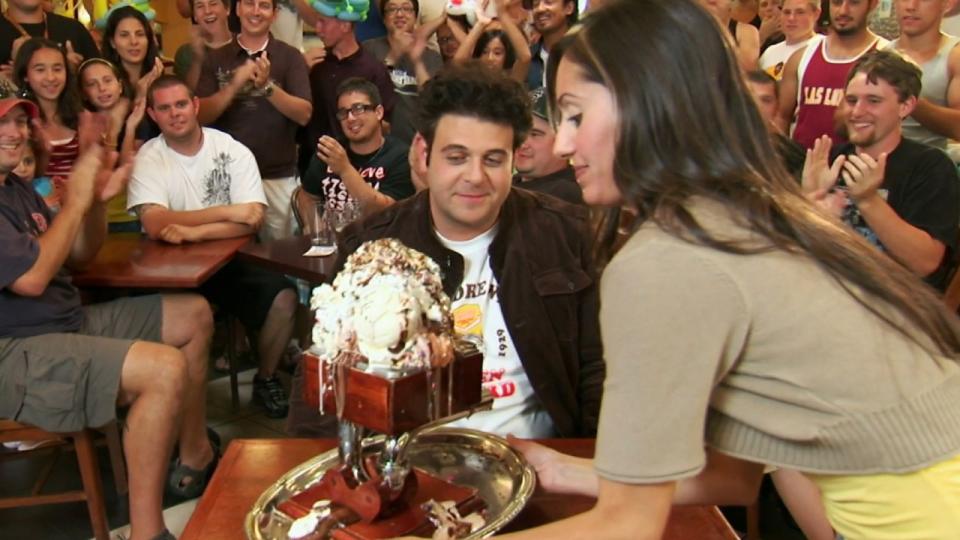 Adam Richman looking at a giant bowl of ice cream in Man v. Food