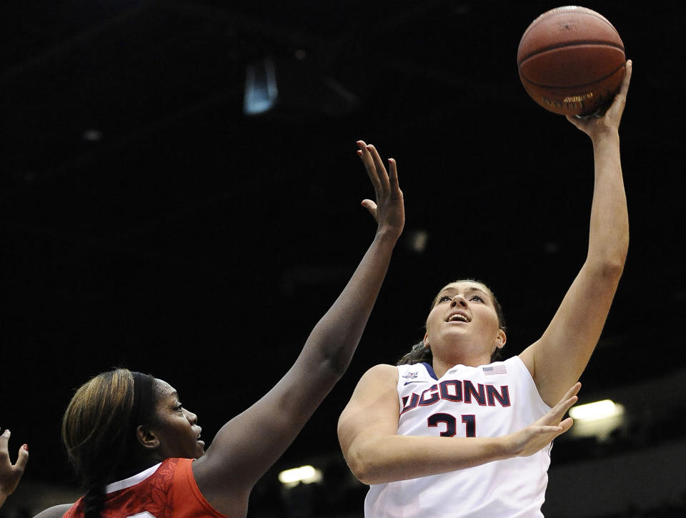 In this Dec. 1, 2013 photo, Connecticut's Stefanie Dolson, right, shoots over Ohio State's Darryce Moore, left, during the first half of an NCAA college basketball game in Springfield, Mass. On Saturday, March 1, 2014, Dolson and fellow senior Bria Hartley will have their names added to the “Huskies of Honor” wall at Gampel Pavilion on the UConn campus in Storrs, Conn. (AP Photo/Jessica Hill, File)