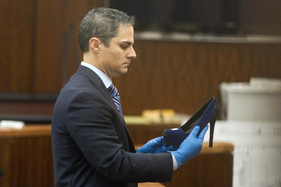 Prosecutor John Jordan shows the jury a stiletto-heeled shoe entered into evidence during the trial against Ana Lilia Trujillo Tuesday, April 1, 2014, in Houston. Trujillo, 45, is charged with murder, accused of killing her 59-year-old boyfriend, Alf Stefan Andersson with the heel of a stiletto shoe, at his Museum District high-rise condominium in June 2013. (AP Photo/Houston Chronicle, Brett Coomer) MANDATORY CREDIT