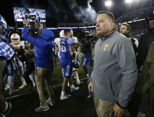 Tennessee head coach Butch Jones walks on the field after his team was defeated by Kentucky 29-26, Saturday, Oct. 28, 2017, in Lexington, Ky. (AP Photo/David Stephenson)