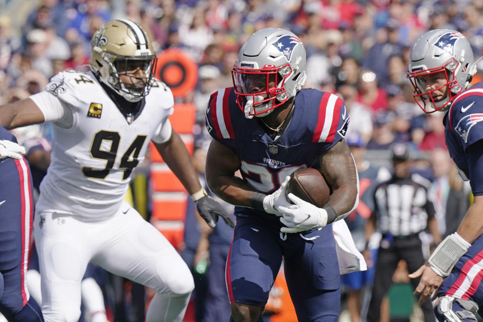 New England Patriots running back James White, center, scrambles past New Orleans Saints defensive end Cameron Jordan (94) during the first half of an NFL football game, Sunday, Sept. 26, 2021, in Foxborough, Mass. (AP Photo/Steven Senne)