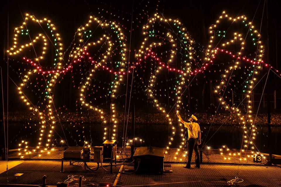 A Disney cast member inspects an Electrical Water Pageant float backstage. Guests may not realize how large they floats are, seeing them from shore.