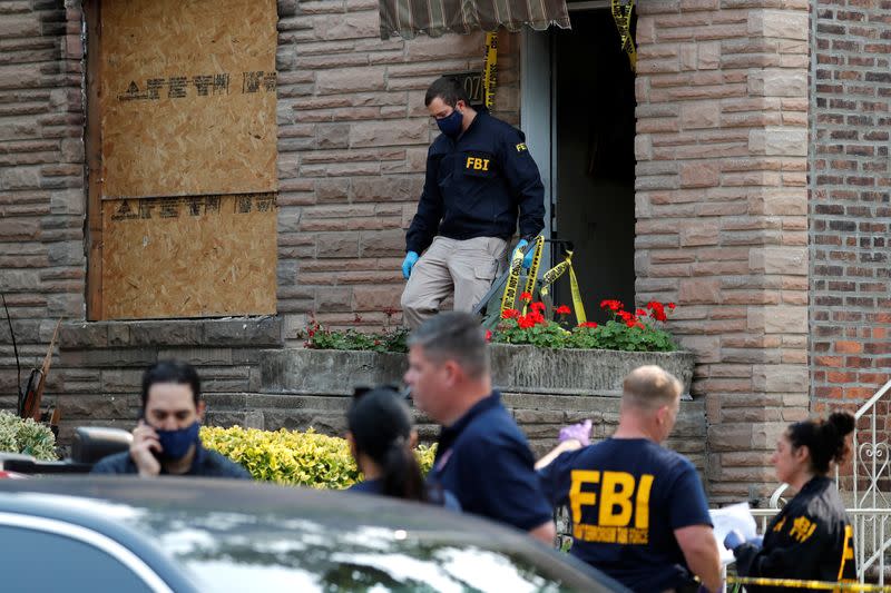 FBI officers outside a house where police say bomb-making materials were found in New York