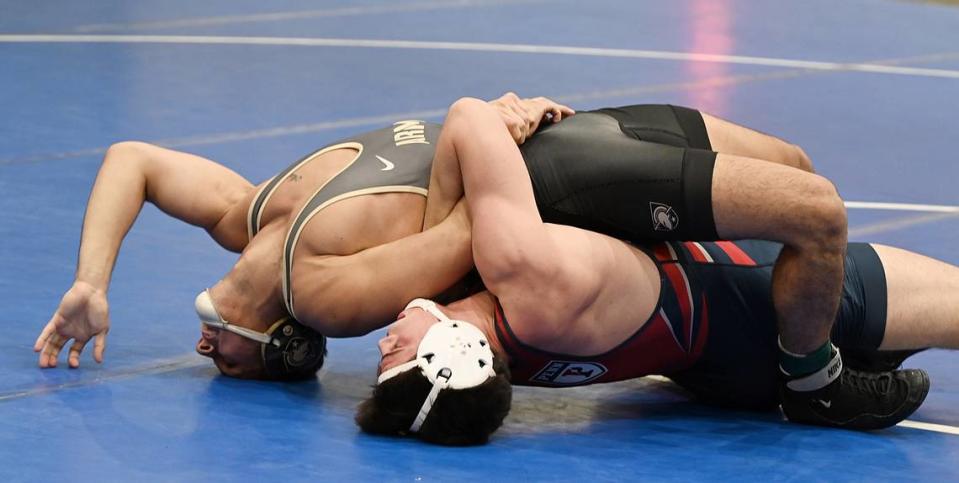 Penn’s Jude Swisher, who is a Bellefonte graduate, looks for back points on Army’s Oscar Aranda in their 157-pound bout of the Journeymen Collegiate Classic on Sunday at Freedom High School in Bethlehem. Swisher was one of four former Centre County wrestlers on the mats on Sunday.