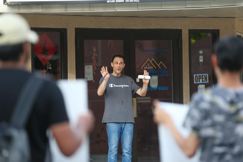 Wesam Abu Ghanieh, the owner of the Blue Nile Restaurant speaks with Purdue University students who are protesting outside of his restaurant over alleged racist comments he made about Indians, on May 5, 2023, in West Lafayette, Ind.