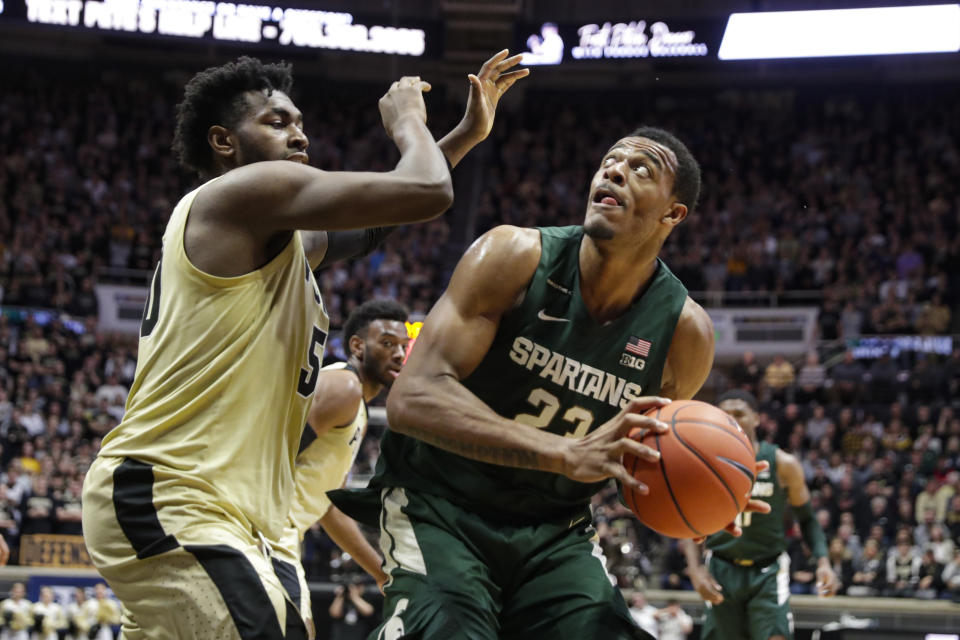 Michigan State forward Xavier Tillman (23) shoots over Purdue forward Trevion Williams (50) during the first half of an NCAA college basketball game in West Lafayette, Ind., Sunday, Jan. 12, 2020. (AP Photo/Michael Conroy)