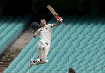 Australian batsman David Warner celebrates scoring a century against the West Indies on the final day of their third cricket test in Sydney January 7, 2016. REUTERS/Jason Reed