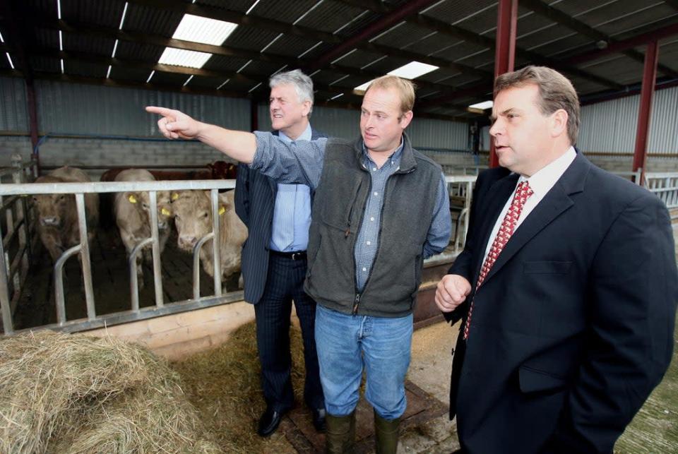 Farmer Ivan McMullan shows then MEP Neil Parish (right) and MEP Jim Nicholson (left) his farm in Carnlough Co Antrim (PA) (PA Archive)
